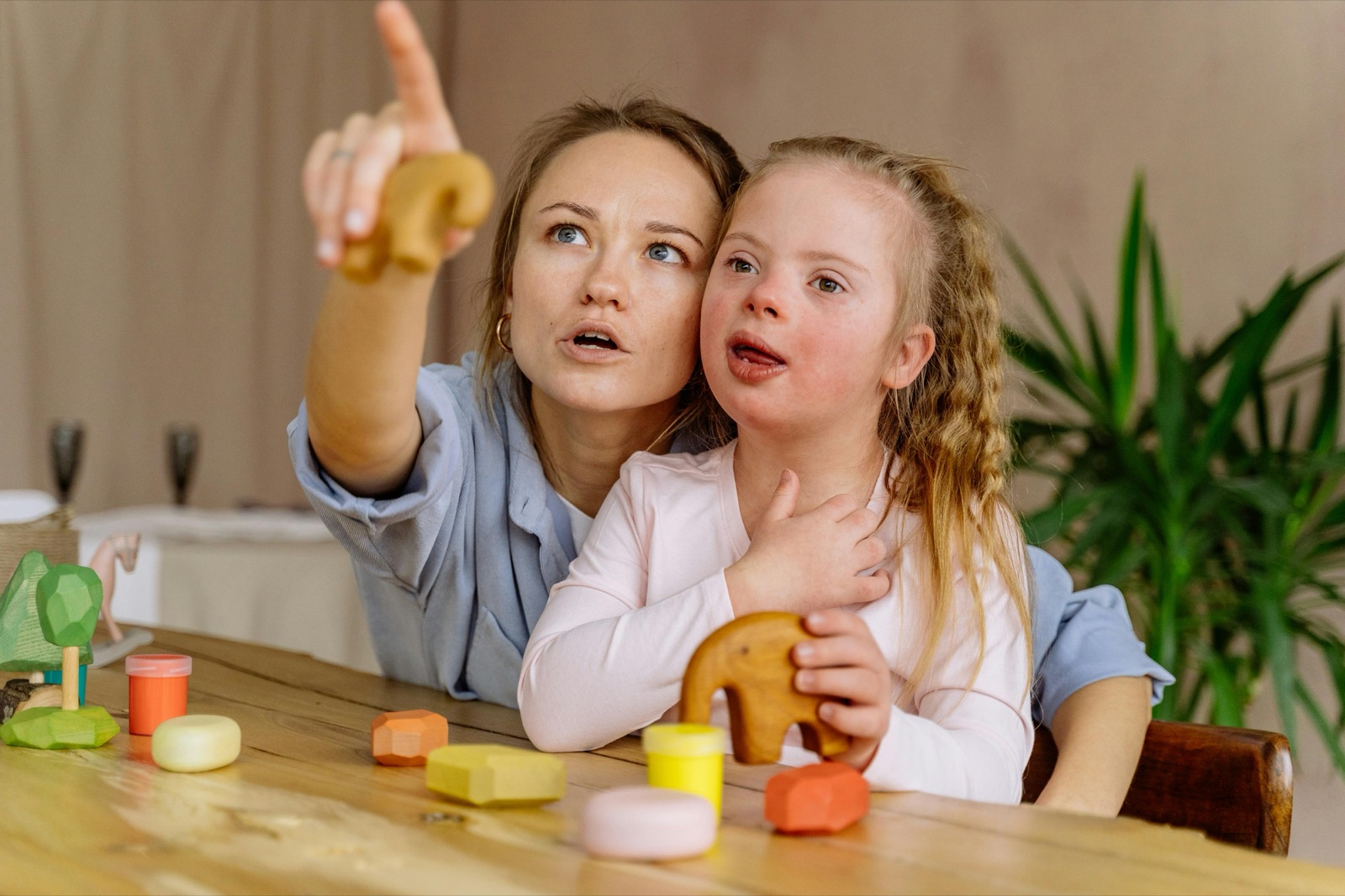 A mother and her daughter, who has Down syndrome, sharing a tender moment together